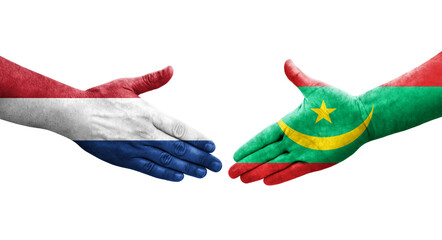 Handshake between Mauritania and Netherlands flags painted on hands, isolated transparent image.