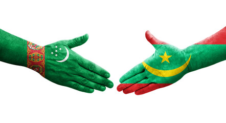Handshake between Mauritania and Turkmenistan flags painted on hands, isolated transparent image.