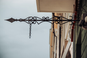 Iron ornament mounted at the exterior of a shop to hang a billboard or an advertisement