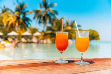 Cocktail glasses at summer poolside, resort beach side. Tropical island closeup outdoor bar cafe or...