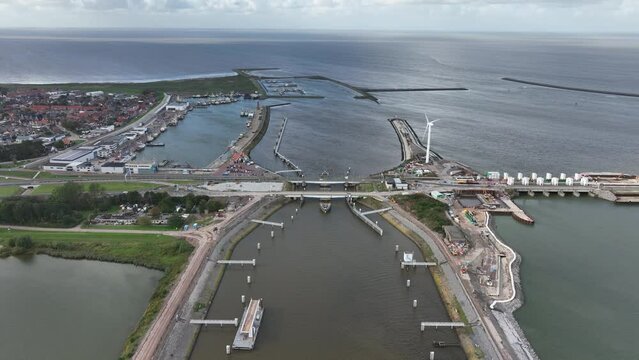 Afsluitdijk construction on pumping stations new sluices and the A7 near Den Oever, Kornwerderzand , and Zurich. Lock for shipping, road traffic cyclists and walkers. Aerial drone view.