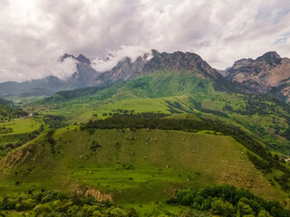 Obraz premium Amazing mountain landscape. Beautiful clouds, fields, mountains. Aerial view