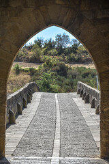 Obraz premium Puente la Reina, Spain - 31 Aug, 2022: Arches of the roman Puente la Reina foot bridge, Navarre, Spain