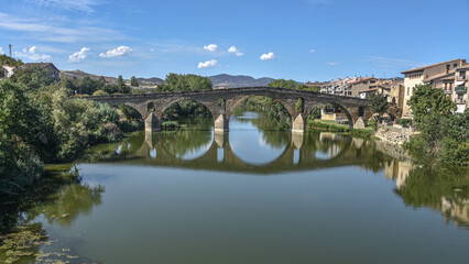 Fototapeta premium Puente la Reina, Spain - 31 Aug, 2022: Arches of the roman Puente la Reina foot bridge, Navarre, Spain