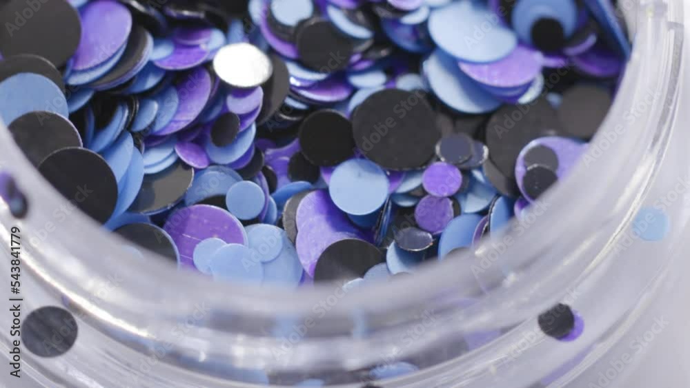 Poster purple sequins in a jar rotate in a circle