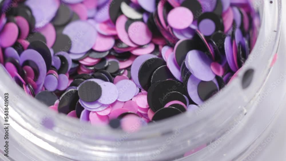 Poster pink sequins in a jar rotate in a circle