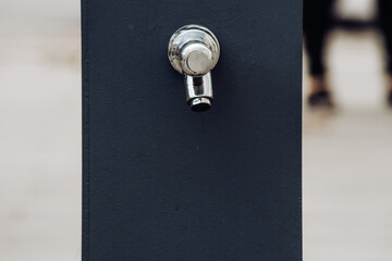 Public drinking fountain made of metal and stainless steel for thirsty people that can consume for...