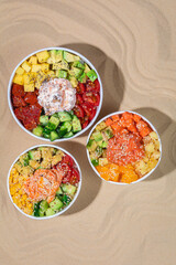 Hawaiian traditional food poke bowl on sand