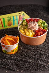 Hawaiian traditional food poke bowl on sand