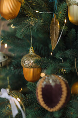 Close up of Christmas Tree decoration in gold colors. Winter holidays background.