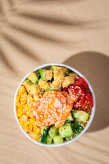 Hawaiian traditional food poke bowl on sand