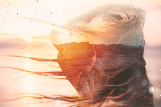 Woman with hair blowing in the wind during sunset
