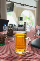 Large glass of beer on the table