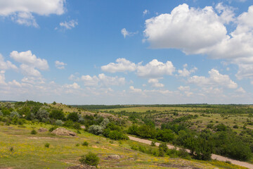 Fototapeta na wymiar A view of the steppe near the Arbuzynsky Canyon near the Trykraty village, on the Arbuzynka river in the Voznesenskyi region of Mykolaiv Oblast of Ukraine