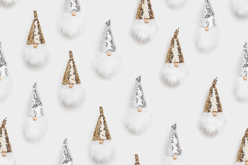 Christmas minimal pattern with cute dwarfs. Winter happy holiday concept. New Year toys dwarf in sparkle cap silver and golden colored on white background.  Minimalist flat lay style, pattern