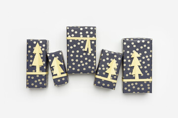 Christmas flat lay, set wrapped paper gift boxes on white fon, diy grey blue packaging presents for holidays. New Year gifts decorated cutting paper fir golden color. Xmas aesthetic minimal pattern