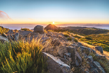 Tourists watching the sunrise over the beautiful mountain landscape of Pico do Ariero. Pico do...
