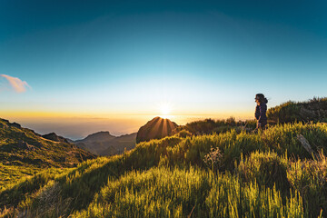 Woman enjoying beautiful mountain landscape of Pico do Ariero during sunrise. Pico do Arieiro,...