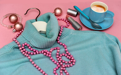 blue turtleneck sweater with modern pearl necklace, lipstick, pink bracelet, cup of espresso coffee...