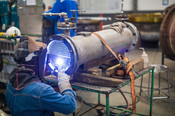 Welding arc argon worker male repaired metal is welding sparks industrial construction repair tube
