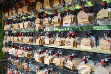 Obraz premium Tokyo, Japan - October, 2022 : Wooden prayer cards at the Meiji Jingu Shrine. Meiji Jingu Greeting Cards. Choose your ema: these are wooden tables you can write wishes on for the future. 