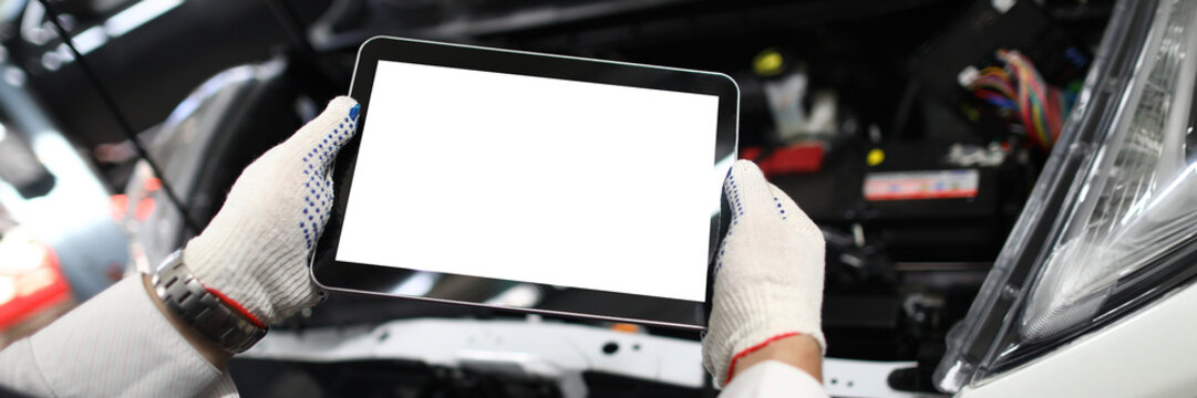 Mechanic worker using tablet for diagnostics of technical condition of vehicle
