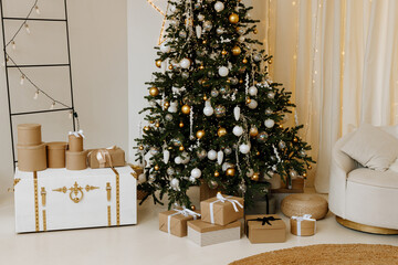 Christmas gifts under the tree. Beautiful boxes with New Year's gifts in a white interior.