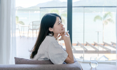 Fototapeta premium woman sitting on sofa