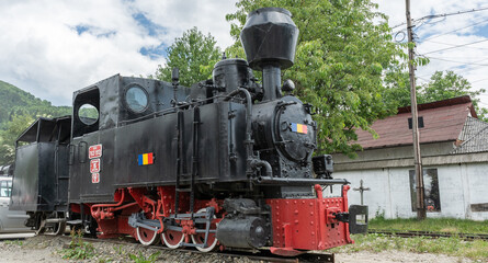 Fototapeta premium Vintage steam train chugging through the Carpathians Mountains in Maramures Romania.