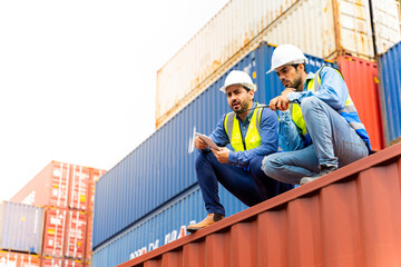Fototapeta na wymiar Two male engineers in a container shipping company Consulting to check the order for the container that is responsible