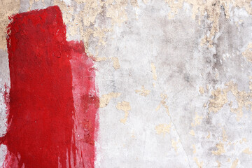 Stained Red Painting on Grunge Concrete Wall Texture Background.