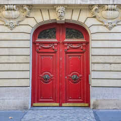 Paris, an ancient red wooden door, beautiful facade in a luxury neighborhood, in the 8e arrondissement - obrazy, fototapety, plakaty