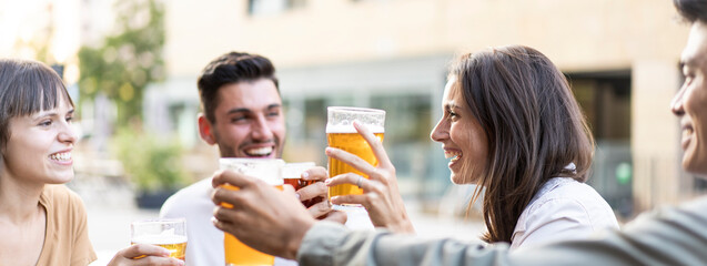 Horizontal banner or header with multiracial friends drinking beer at brewery pub - Genuine friendship life style concept with guys and girls enjoying happy hour food together at open air bar dehor
