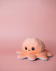 pink kind octopus toy on a pink background