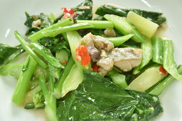 fried Chinese kale with chop salty fish in oyster sauce on plate 
