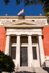 Fototapeta na wymiar Entrance to the Royal Spanish Academy (RAE) building with flag on top