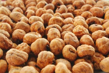 Close-up of chufa, tigernut, earth ground Almond, groundnut, tiger nut, zulu nut, sweet root, tuberous grass, wintergrass, succulent food. Nut for drink horchata, table oil, natural soap. Health idea