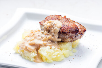 grilled meat with mashed potatoes with onion sauce