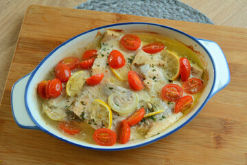 Trout fillets baked with butter, tomatoes and lemon.