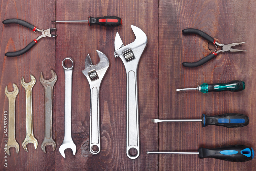 Wall mural variety of repairman tools for repair work on wooden workshop. view from above.