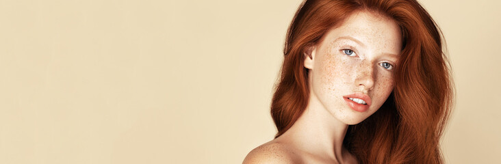 Beauty Freckles young  girl portrait. Attractive model with beautiful natural ginger red hair