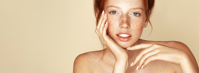 Pigmentation. Skin complexion. Freckles young girl close up portrait. Attractive model with...