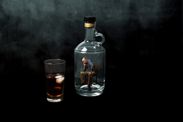 Man trapped in an empty bottle, sitting on a chair, contemplating a glass of whisky, with a black...