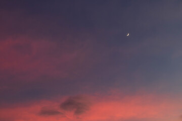 Crescent moon on beautiful sunset sky background.