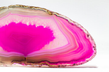 Hot pink and semi-transparent agate geode slice crystal, banded chalcedony stone isolated on a...