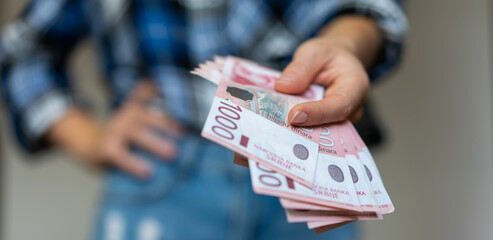 Serbian 1000 dinars banknotes cash in hand. - obrazy, fototapety, plakaty