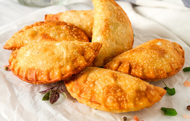 Fried chebureks, close-up, on a light background, no people,