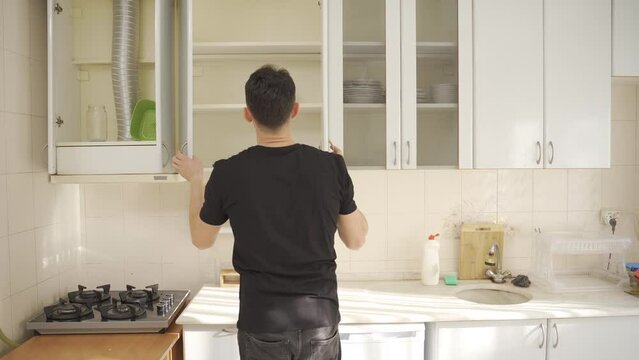 The hungry man is experiencing food shortages.
The man who hungrily ate the little food he found in the cupboard.
