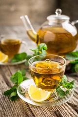 Sierkussen Fresh mint tea with lemon on the wooden table © pilipphoto