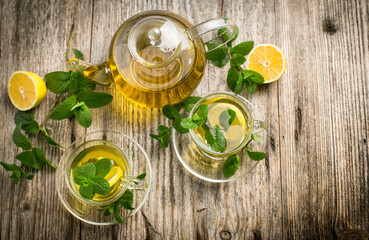Fresh mint tea with lemon on the wooden table